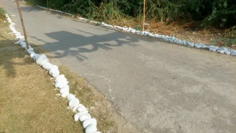 Paved Rural Pathway Lined With Decorative White Stones During Daytime Stock Photos