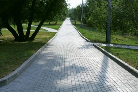 Paved tile road in the park Stock Photos