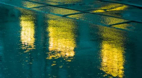 Pavement after the rain with light reflections Stock Photos