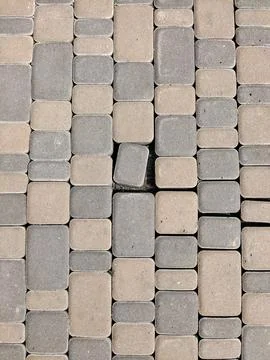 The pavement is made of bricks of different colors, multi-colored tiles Stock Photos