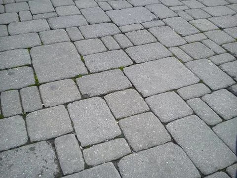 A pavement made of rectangular stone slabs. Stock Photos