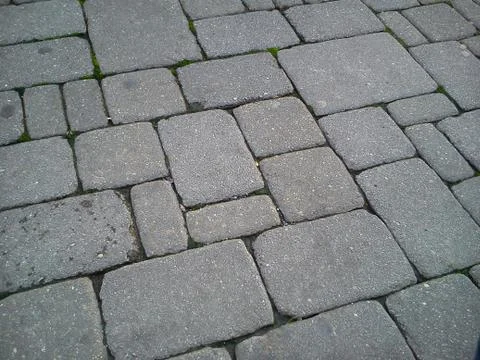 A pavement made of rectangular stone slabs. Stock Photos