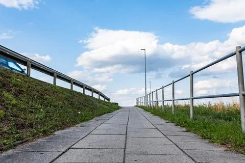 Pavement path around greenery in peri urban areas Foto stock