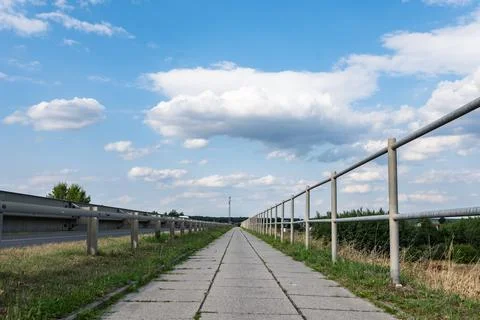 Pavement path around greenery in peri urban areas Foto stock