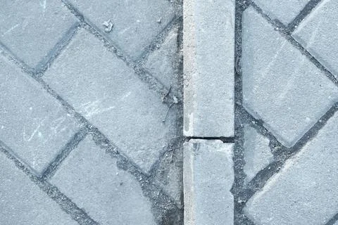 Pavement pattern made of rectangular blocks of grey stone bricks Stock Photos