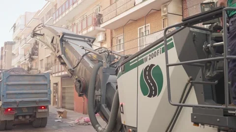 Pavement recycling, milling machine throwing reclaimed asphalt into truck Stock Footage 253233318