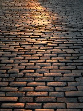 Pavement with a reflection of the sun Stock Photos