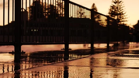 Pavement reflections at a seaside resort at sunset slow motion dolly 4K Stock Footage 258881181
