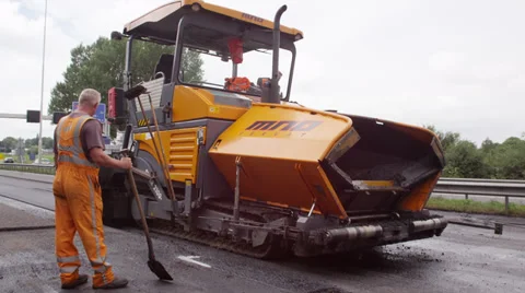 Paver (asphalt) machine slowly crawling by Stock Footage 37433511