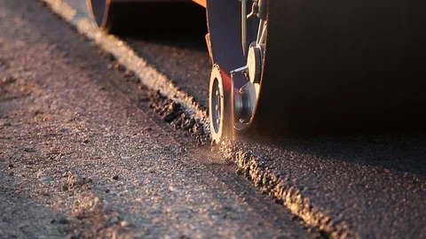 The paver mover on a flat newly made road, ramming and leveling. Asphalt paver Stock Footage 129217677