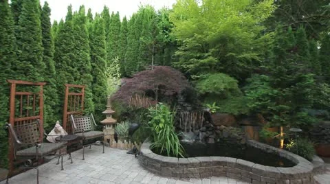 Paver Stone Garden Backyard Waterfall with Bistro Furniture 1080p Stock Footage 11747206