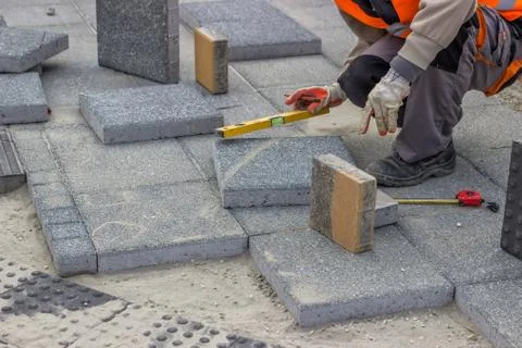 Paverlaying concrete bricks Stock Photos