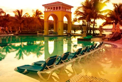 Pavilion on a sunset and the pool with reflection Stock Photos