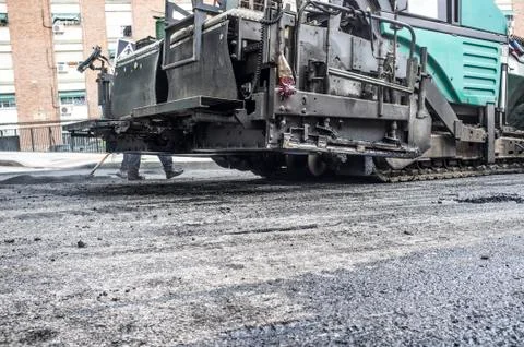 Paving applicator machine or paver at work Stock Photos