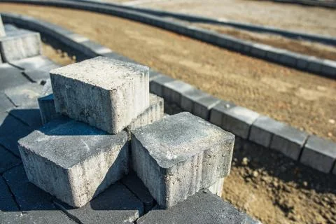 Paving Bricks Closeup. Brick Cobbles. Paving Works. Stock Photos