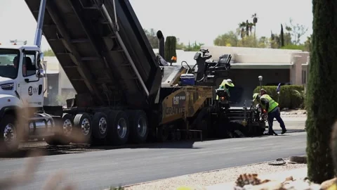 Paving machine and crew resurfacing a neighborhood street Stock Footage 152797725