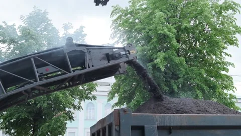 Paving machine pours out debris. Renovation work concept. Stock Footage 157054933
