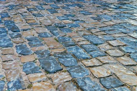 Paving pattern with rectangular shape. Old stone road on street of old town. Stock Photos