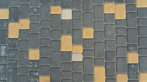 The paving slabs are multicolored, gray, white and orange Stock Photos