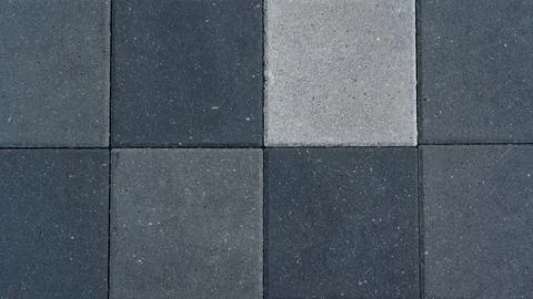 The paving slabs are square in shape. Square paving slabs of different colors Stock Photos