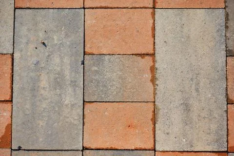 Paving slabs of rectangular colored brick. Texture of concrete blocks Stock Photos