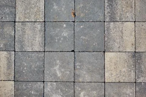 Paving slabs of square brick. Texture of concrete blocks Stock Photos