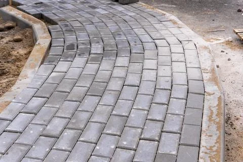 The paving stone path during construction. Improvement of the city territory. Stock Photos