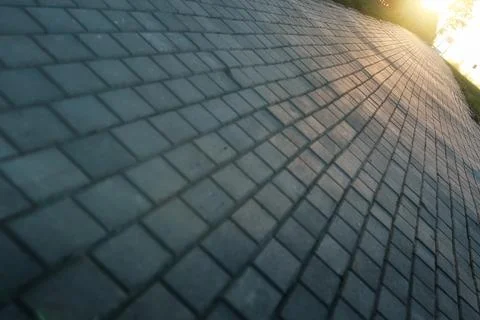 Paving stone path goes away the prospect in sunset Stock Photos