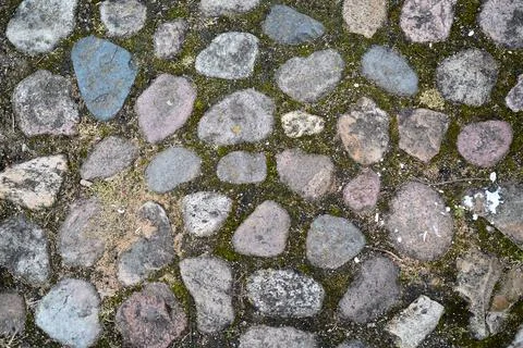 Paving stone, texture background. Cobble pattern. Old road detail. Ancient path Stock Photos