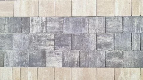 Paving surface road. Texture made of big gray cement bricks. Gray paving stones. Stock Photos