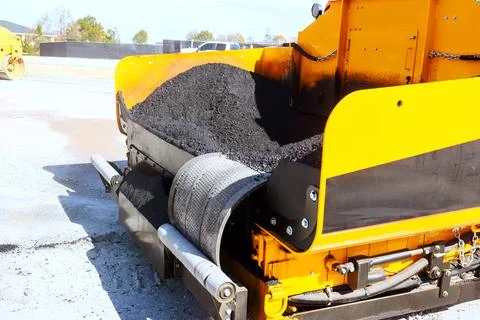 Paving workers operate asphalt machine to lay new asphalt at road construct.. Stock Photos