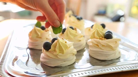 Pavlov’s cake is decorated with a mint leaf. Stock Footage 118442933