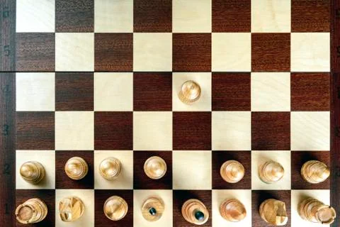 A pawn doing the first move on a chessboard at the very beginning of the game 写真素材