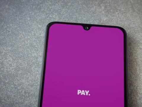 PAY app launch screen with logo on the display of a black mobile smartphone o Stock Photos