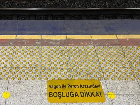 Pay attention to the gap between wagon and platform sign. Stock Photos