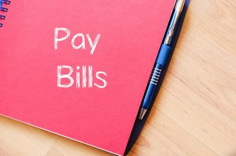 Pay bills write on notebook Stock Photos