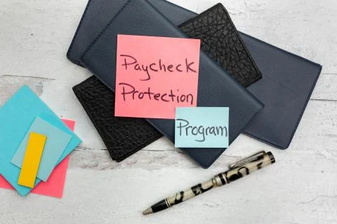 Pay check protection program on note with chackbooks in the background Stock Photos