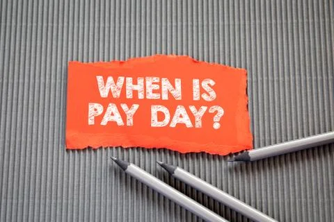 PAY DAY concept. Text on torn, colored paper on corrugated background Stock Photos