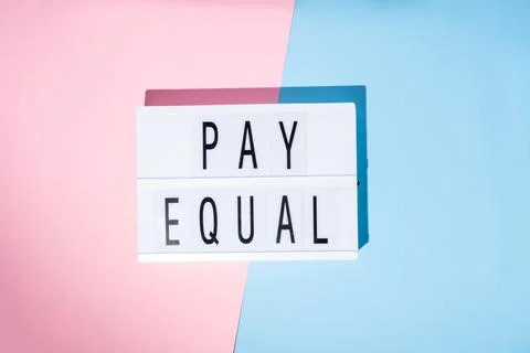 Pay Equal text on the lightbox. Concept of feminism on a blue and pink Stock Photos