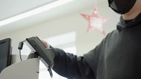 Pay for goods through the terminal in a contactless way in a supermarket. Using Stock Footage 145795656