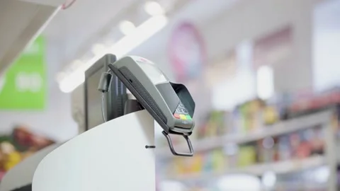 Pay for goods through the terminal in a contactless way in a supermarket. Using Stock Footage 149671471