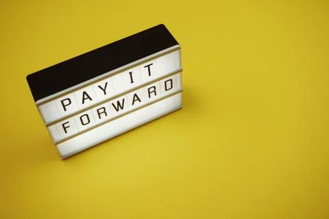 Pay It Forward word in light box with space copy on yellow background Stock Photos
