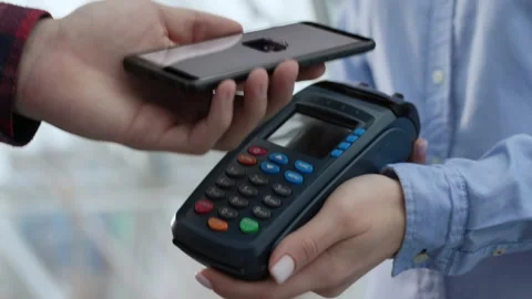 Pay by phone on electronic payment machine or card reader. E-money at cashless w Stock Footage 199480672
