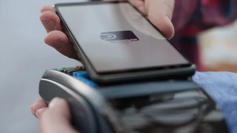 Pay by phone on electronic payment machine or card reader of mall. E-money at ca Stock Footage 199480695