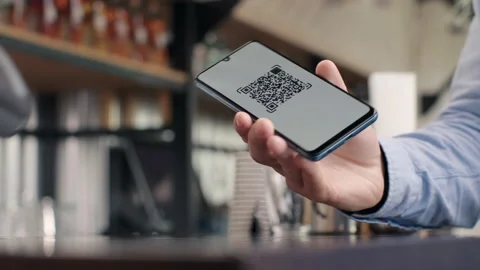 Pay by qr code on phone screen at coffee bar. Qr reader scans electronic card to Stock Footage 199485837