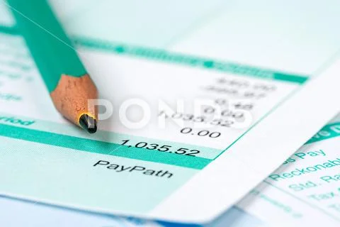 Pay slip and and pencil Stock Photos