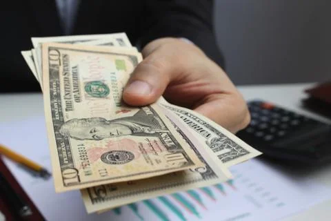 Pay the US dollar , Hand use dollar money on the office desk  investment and  Stock-Fotos