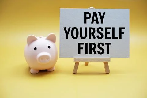 Pay Yourself First text and piggy bank for saving on yellow background Stock Photos
