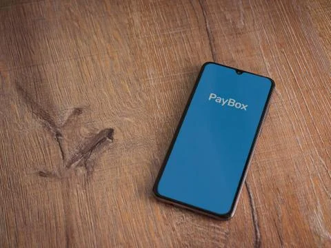 PayBox app launch screen with logo on the display of a black mobile smartphon Stock Photos