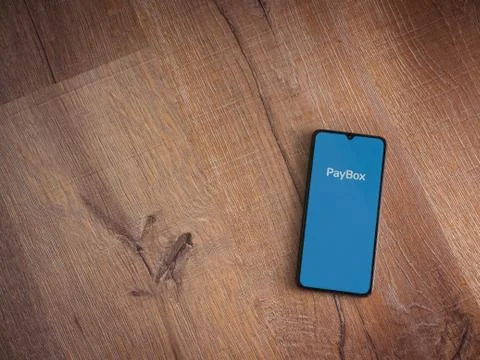PayBox app launch screen with logo on the display of a black mobile smartphon Stock Photos